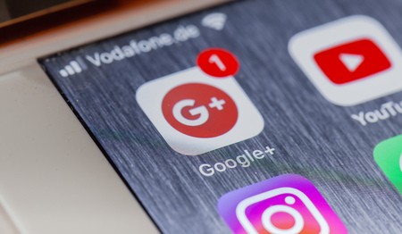 BERLIN, GERMANY - OCTOBER 15, 2018: Google Plus app on screen of an iPhone 7 Plus with personalized backgroundのeditorial素材