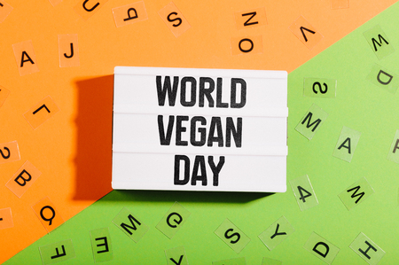 World Vegan Day message written in light box on bicolor table desk flat layの写真素材