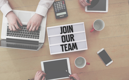 Join Our Team message written in light box on office desk flat layの写真素材