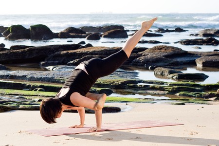 caucasian woman practise yoga on beach