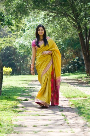 beautiful indian woman walking in gardenの写真素材