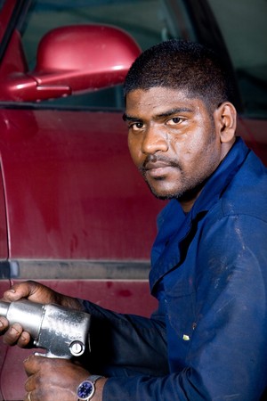 indian mechanic changing vehicle tyreの写真素材