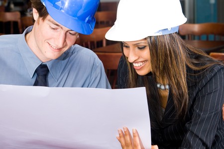 construction manager and indian female construction worker in a cafe