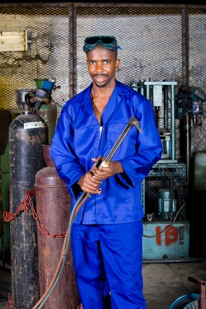 african male welder with gas welding machineの写真素材