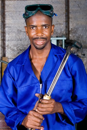 african male welder with gas welding machineの写真素材