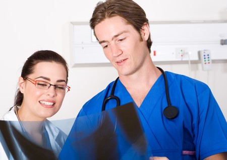 doctors looking at patient's x-ray film