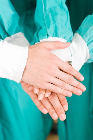 doctors with hands together to form a medical teamwork