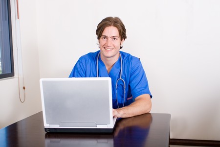 male doctor working on laptop computerの写真素材