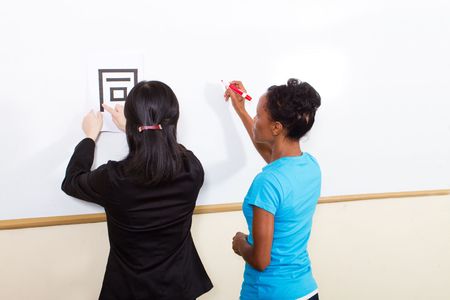 teacher helping student learn chinese writingの写真素材