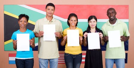 group of diverse south africans holding up blank signs in front of flagの写真素材