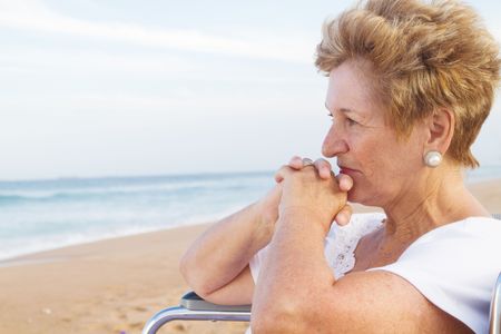 thoughtful senior woman in wheelchairの写真素材
