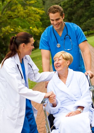 doctor greeting patient in hospital gardenの写真素材