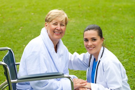 private nurse and happy patient in parkの写真素材