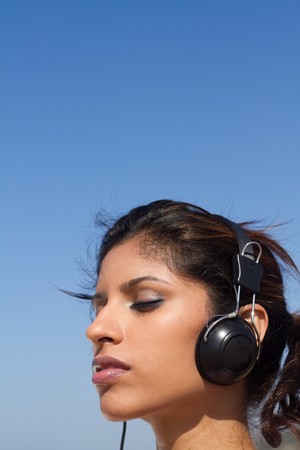 close-up of pretty woman listening to musicの写真素材