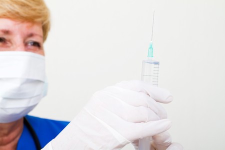 nurse measuring medicine in syringeの写真素材