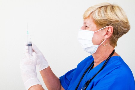 female nurse holding syringeの写真素材