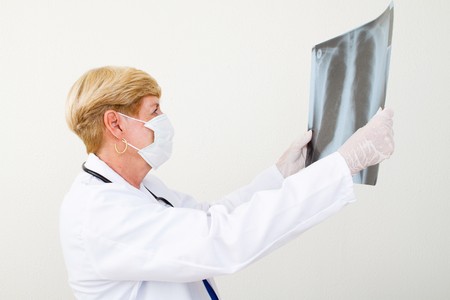 senior female doctor examining x-rayの写真素材