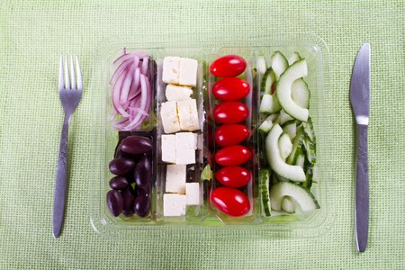 fresh greek salad in plastic bowlの写真素材