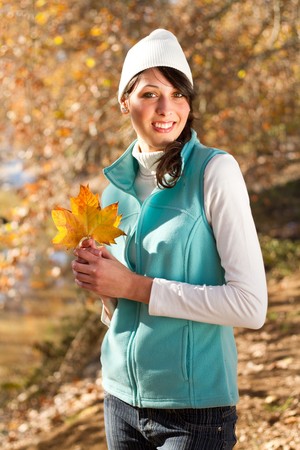 beautiful autumn woman outdoorsの写真素材