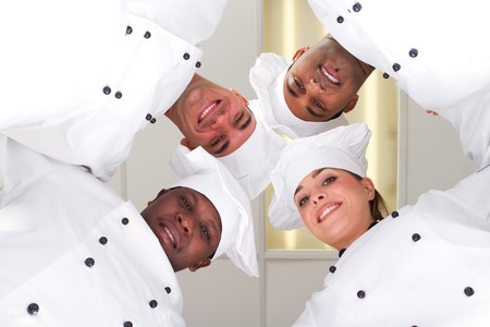group of chefs heads together for form a teamの写真素材