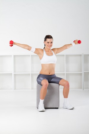 pretty fitness woman lifting weightsの写真素材
