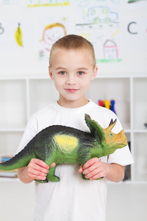 preschool boy playing with dinosaurの写真素材