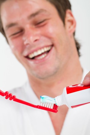 happy young man brushing teethの写真素材