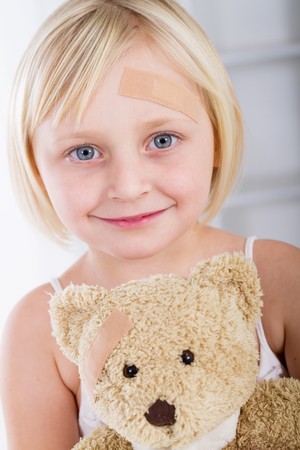 cute little girl with plaster on foreheadの写真素材