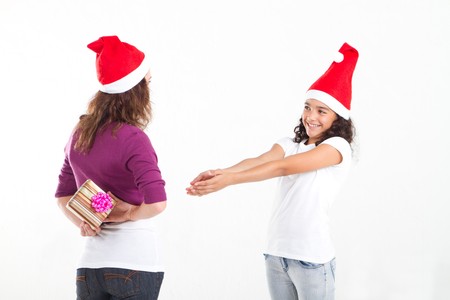 cute daughter asking mother for christmas giftの写真素材