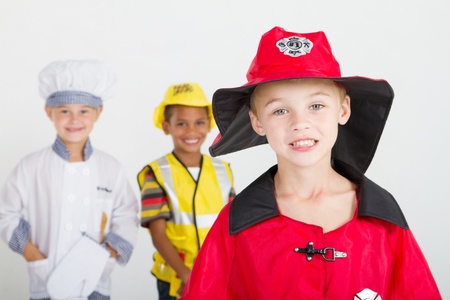 little boy as firefighter, background is kids as chef and construction workerの写真素材