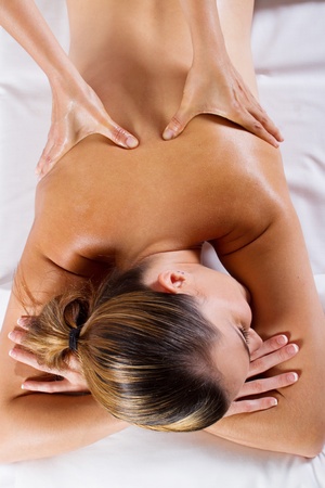 young woman receiving back massageの写真素材