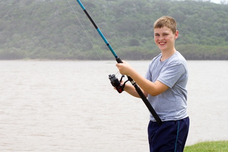 teengae boy fishing by the lakeの写真素材