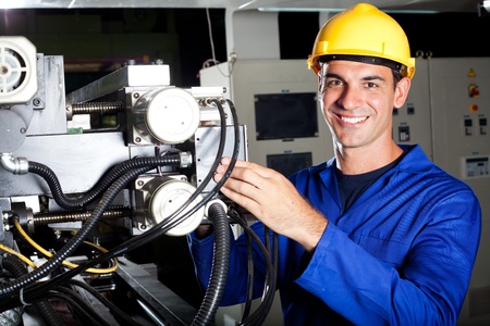 happy modern industrial machine operator at work happy modern industrial machine operator at work