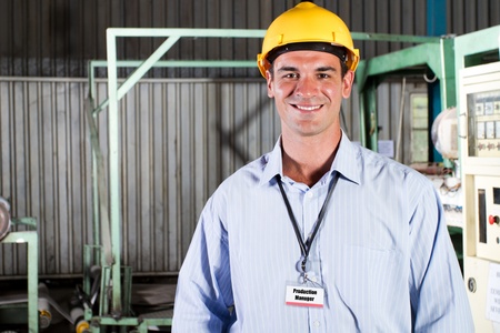happy male production manager portrait inside factory
