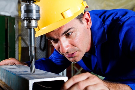 male metal worker using drillpress