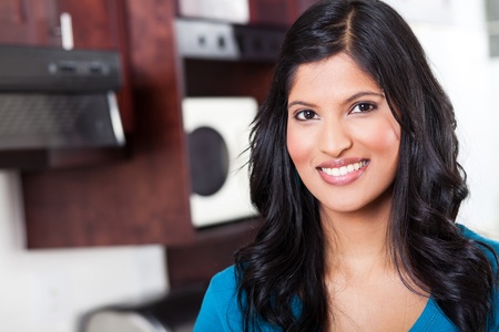 beautiful young indian woman portrait in kitchenの写真素材