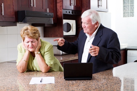 senior husband pointing fingers at his wife