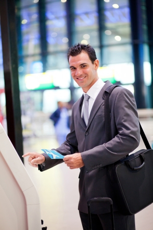businessman using self help check in machine at airportの写真素材