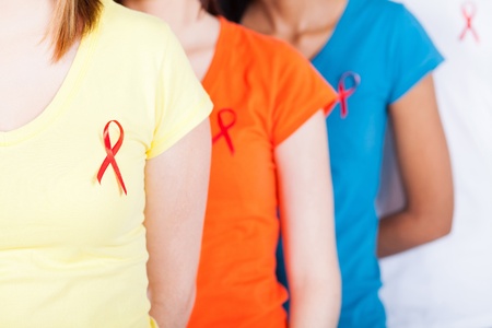 group of young people with red ribbon on their chest for AIDS HIV awareness