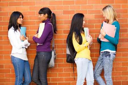 young female college friends chatting の写真素材
