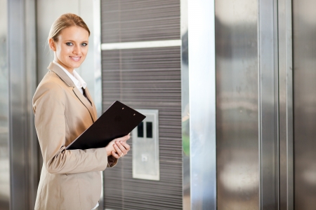 young businesswoman waiting for elevator in the buildingの写真素材