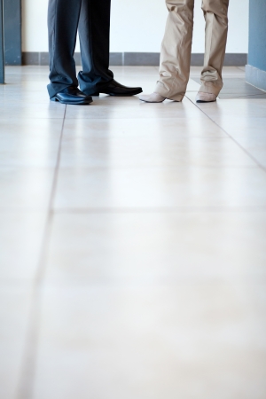 businesspeople standing on office floorの写真素材