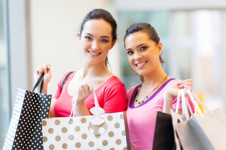 happy young women with shopping bagsの写真素材
