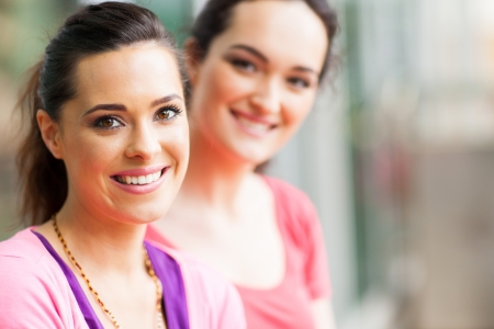 two young women friends closeup portraitの写真素材