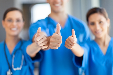 group of healthcare workers thumbs upの写真素材