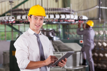 modern textile factory manager using tablet computer modern textile factory manager using tablet computer