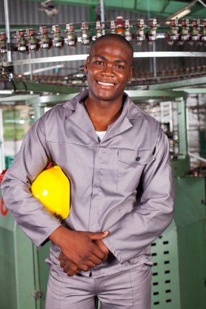 african american blue collar industrial worker in factoryの写真素材