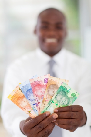 young south african businessman holding new bank notesの写真素材