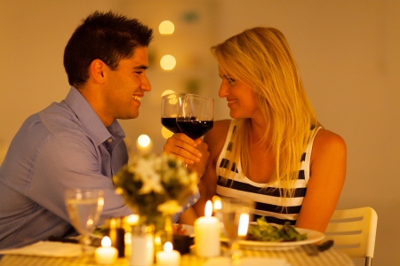 loving young couple enjoying a glass of wine in restaurantの写真素材