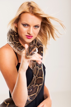 sexy young blonde woman with pythonの写真素材